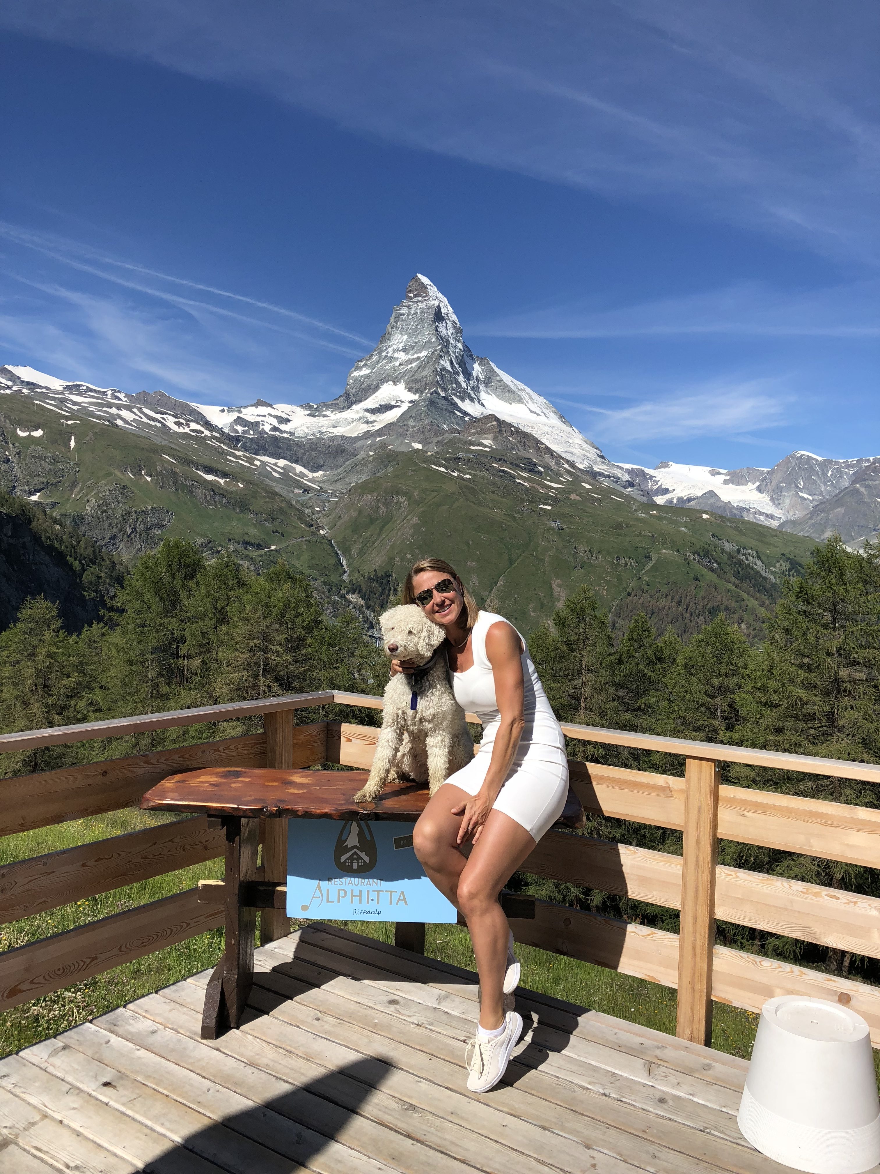 Tanja together with her dog, Marley on the terrace and in the background the Matterhorn