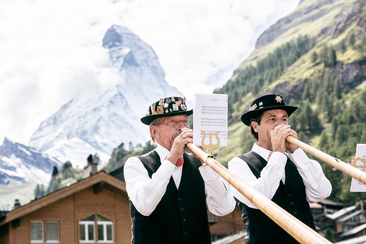 Zwei Männer mit riesen Trompeten vor dem Matterhorn